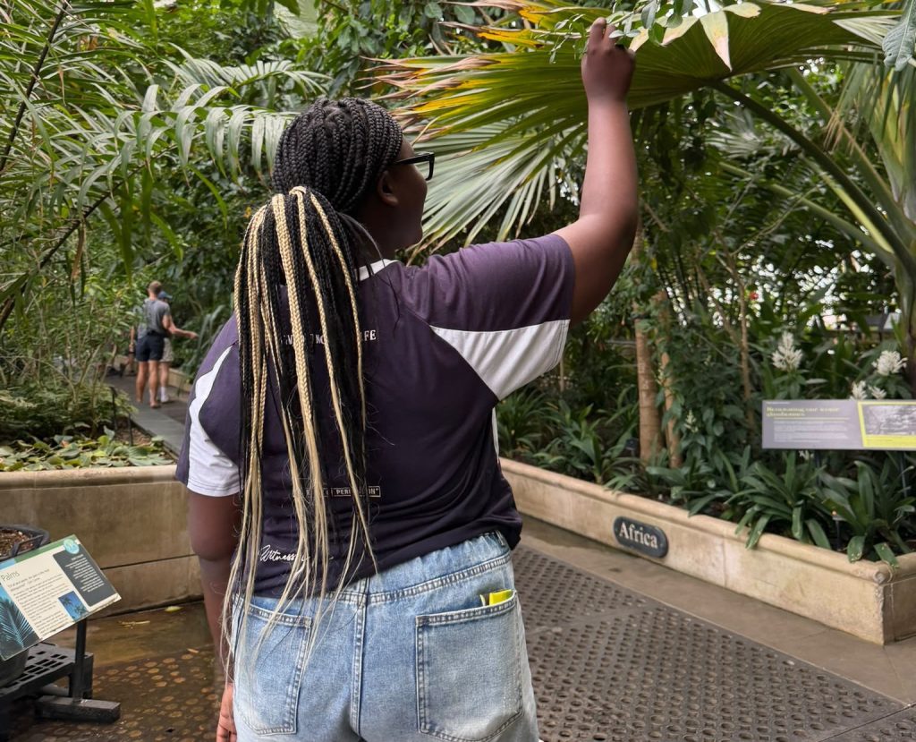 Girl looking at a plant at Kew