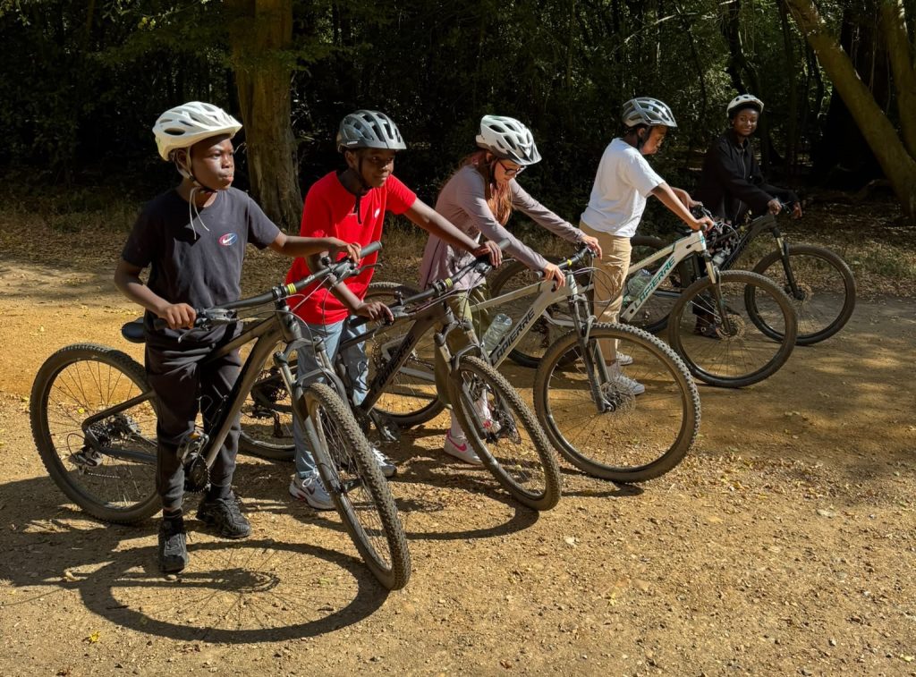 five young people on their bikes